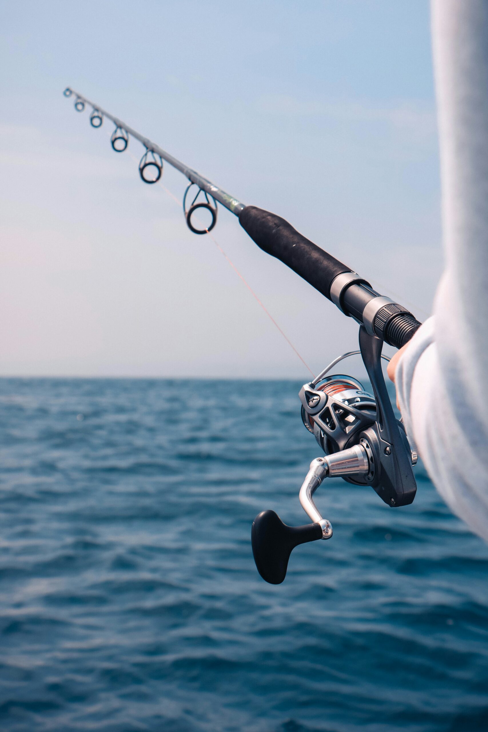 man holding light tackle fishing rod